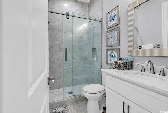 bathroom featuring walk in shower, vanity, and toilet