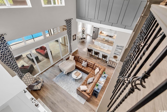 living room featuring a high ceiling and hardwood / wood-style flooring