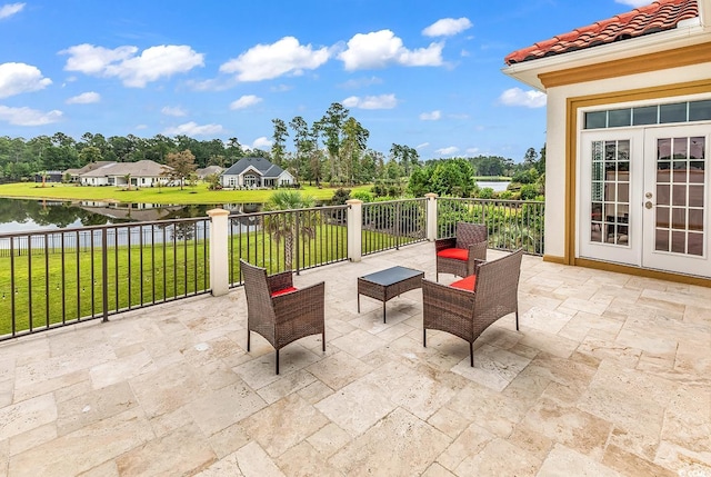 view of patio featuring a water view and french doors