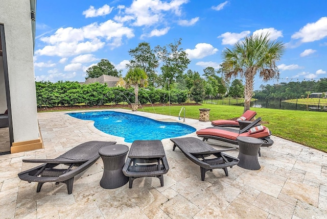 view of swimming pool featuring a lawn and a patio