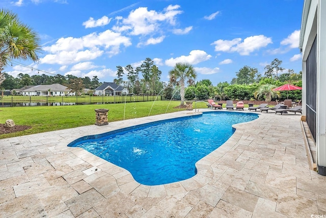 view of swimming pool with a yard and a patio