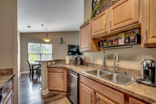 kitchen with sink, lofted ceiling, decorative light fixtures, hardwood / wood-style floors, and stainless steel dishwasher