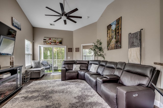 living room with ceiling fan, hardwood / wood-style floors, and high vaulted ceiling