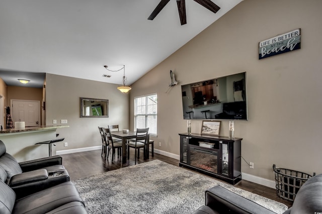 living room featuring ceiling fan, dark hardwood / wood-style floors, and high vaulted ceiling