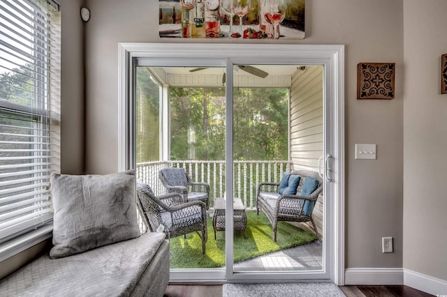 living area featuring ceiling fan, hardwood / wood-style flooring, and a healthy amount of sunlight