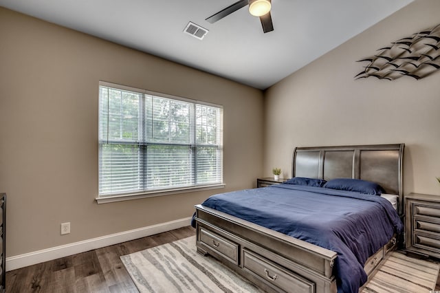 bedroom featuring ceiling fan, wood-type flooring, lofted ceiling, and multiple windows