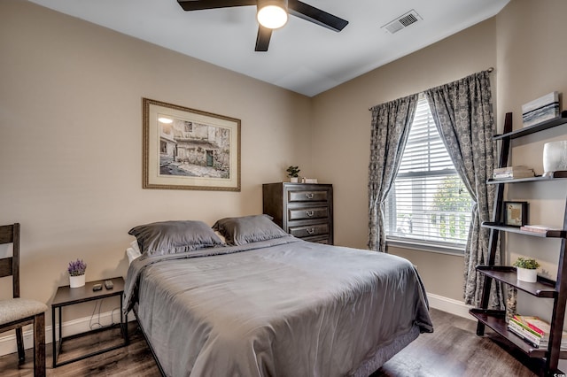 bedroom with ceiling fan and dark wood-type flooring