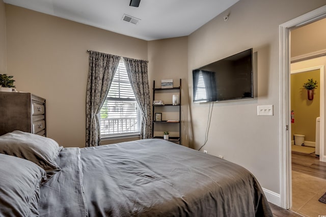 bedroom with light tile patterned flooring and ceiling fan