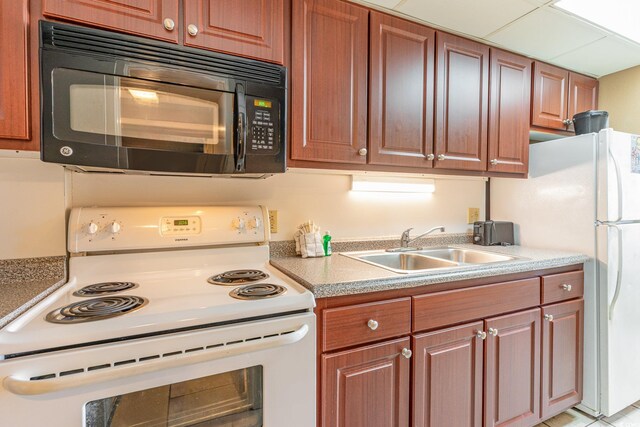 kitchen featuring white appliances and sink