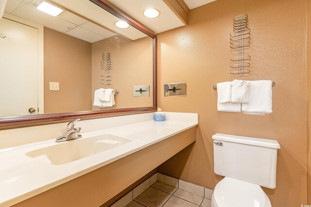 bathroom featuring tile patterned flooring, vanity, and toilet