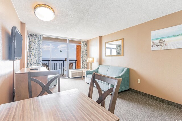 dining area featuring a textured ceiling and light carpet