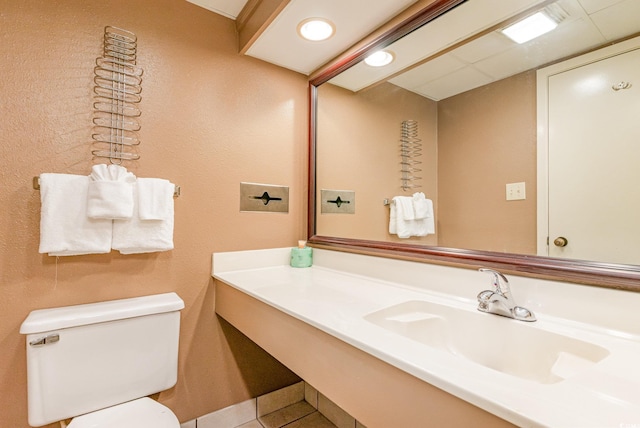 bathroom featuring vanity, toilet, and tile patterned floors