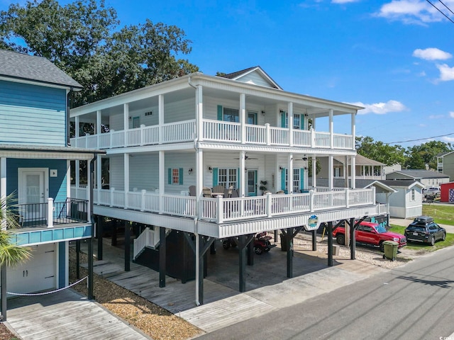 back of house with a balcony and a carport