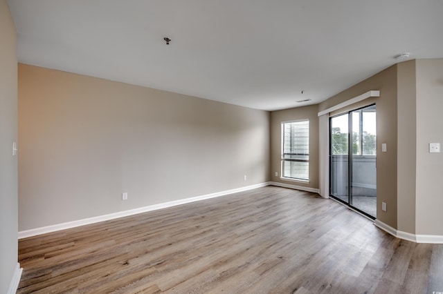 empty room with light hardwood / wood-style flooring