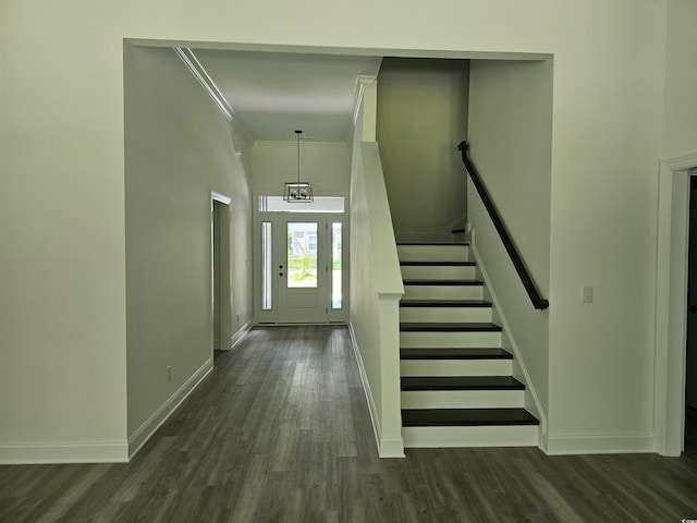 stairway with ornamental molding and wood-type flooring