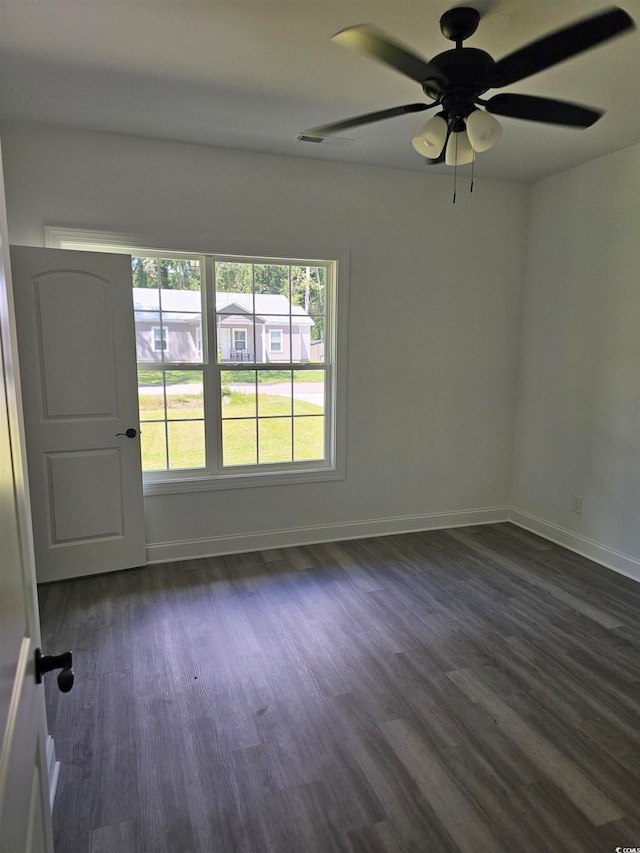 spare room featuring dark hardwood / wood-style flooring and ceiling fan