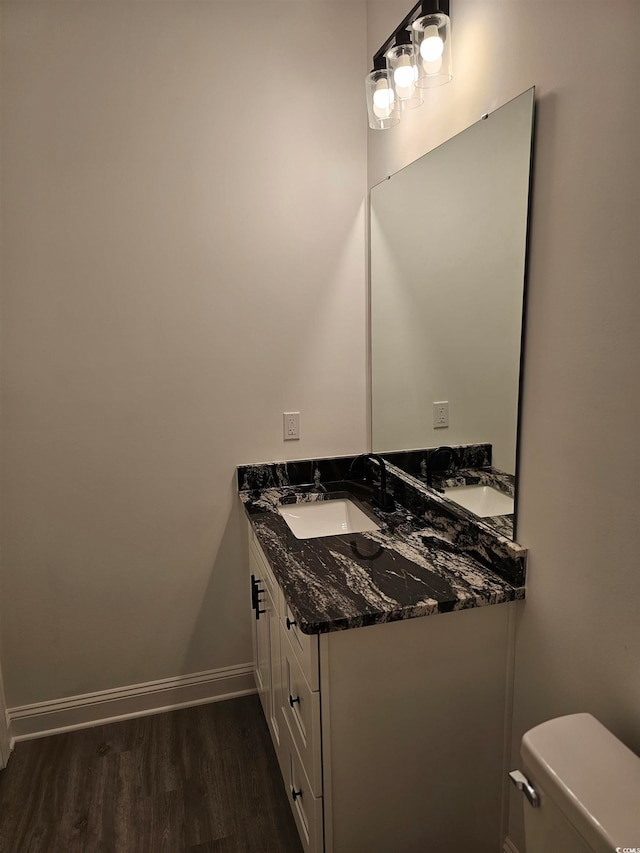 bathroom featuring hardwood / wood-style flooring, vanity, and toilet