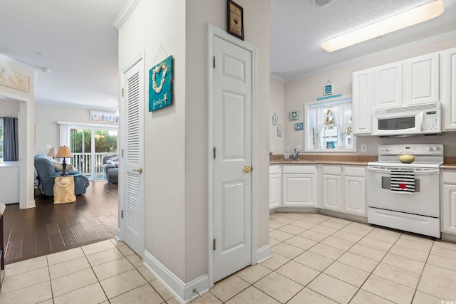 kitchen with range with electric stovetop, white cabinets, a textured ceiling, light hardwood / wood-style flooring, and ornamental molding