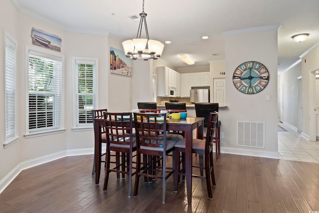 1100 Commons Blvd Unit 104, Myrtle Beach, SC 29572 - dining area featuring ornamental molding, a chandelier, recessed lighting, and hardwood / wood-style floors
