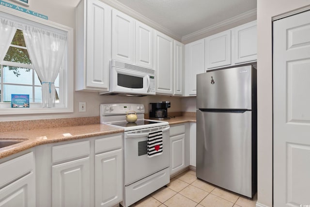1100 Commons Blvd Unit 104, Myrtle Beach, SC 29572 - kitchen with white appliances, white cabinets, light tile patterned floors, light countertops, and ornamental molding