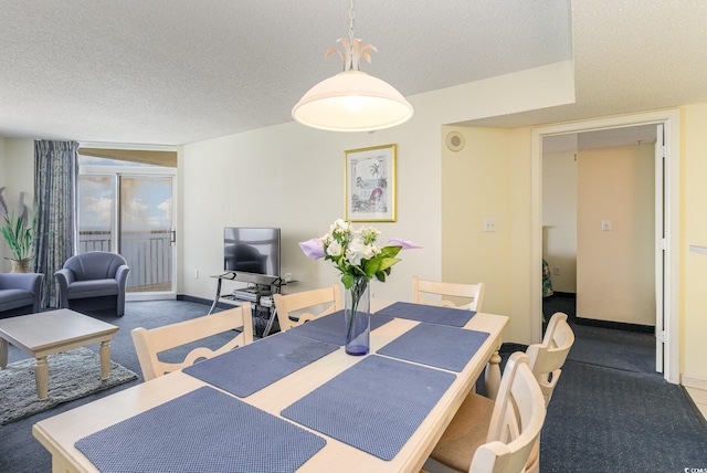 carpeted dining space featuring a textured ceiling