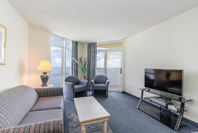 living room with carpet floors, a textured ceiling, and a wall of windows