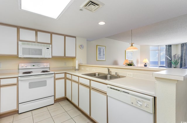 kitchen featuring sink, white cabinetry, kitchen peninsula, hanging light fixtures, and white appliances