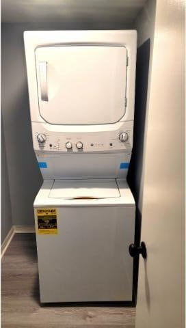 10166 Beach Dr Unit 5306, Calabash, NC 28467 - laundry room with stacked washing machine and dryer, wood finished floors, and baseboards