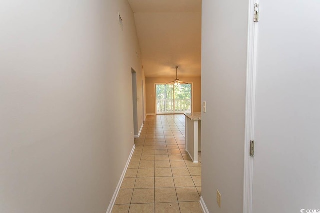 hall with light tile patterned floors