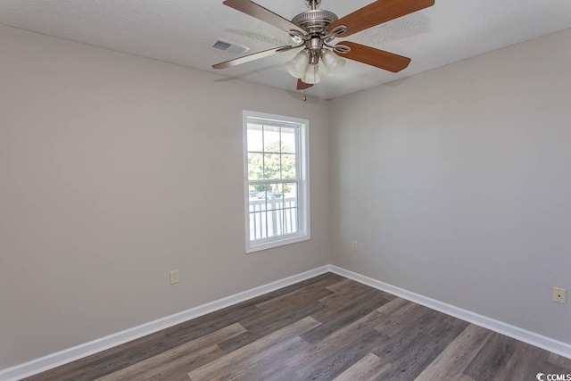 empty room with dark wood-type flooring, ceiling fan, and a textured ceiling