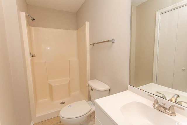 bathroom with vanity, toilet, a textured ceiling, and walk in shower