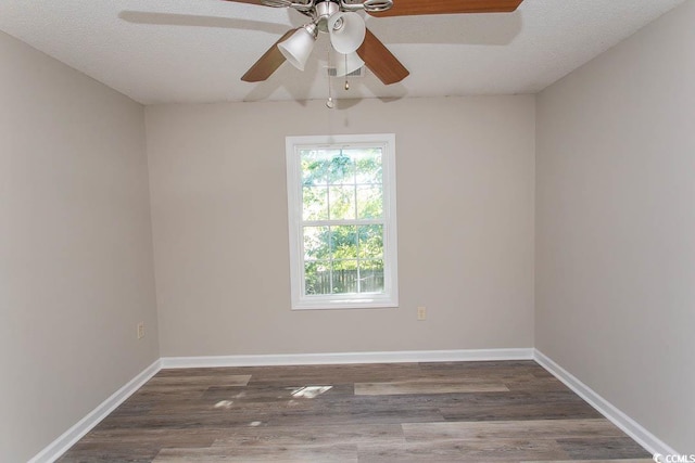 unfurnished room featuring dark wood-type flooring, a textured ceiling, and ceiling fan