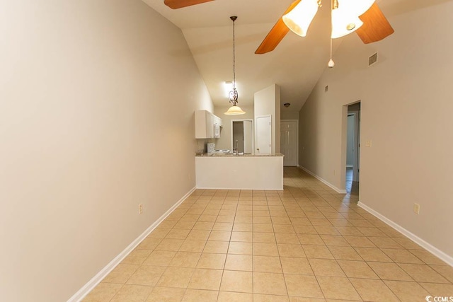 unfurnished living room with ceiling fan, high vaulted ceiling, and light tile patterned floors