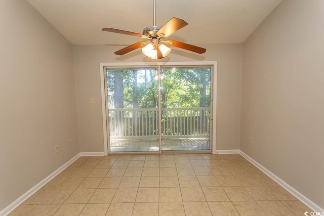 tiled spare room featuring ceiling fan