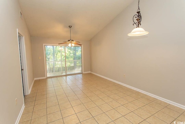 empty room featuring lofted ceiling, light tile patterned floors, and ceiling fan