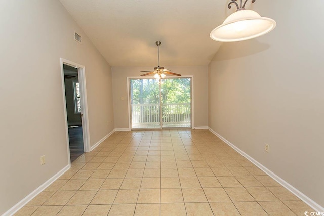 tiled spare room featuring ceiling fan and vaulted ceiling