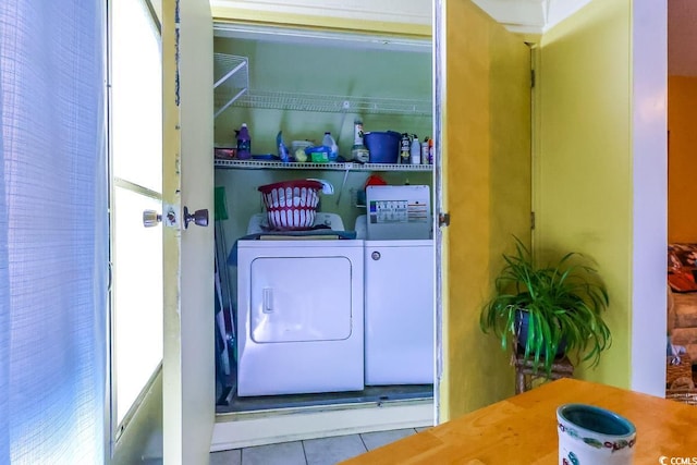 washroom with light tile patterned floors, plenty of natural light, and washer and dryer