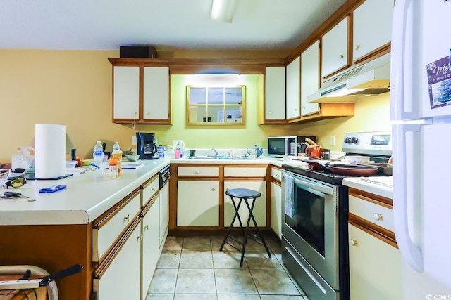 kitchen featuring electric stove, light tile patterned floors, white cabinetry, and white fridge