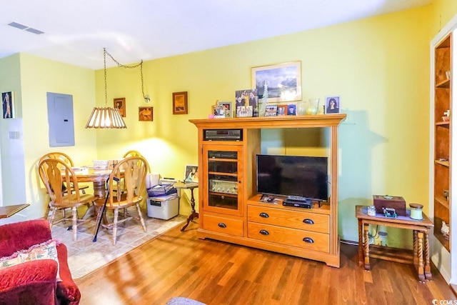 living room with hardwood / wood-style floors and electric panel