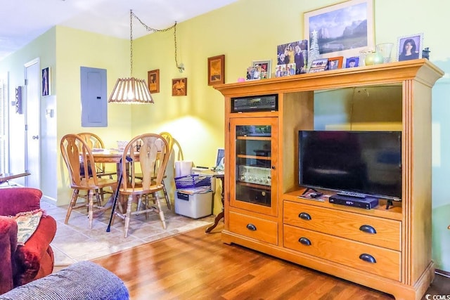 living room with light wood-type flooring and electric panel