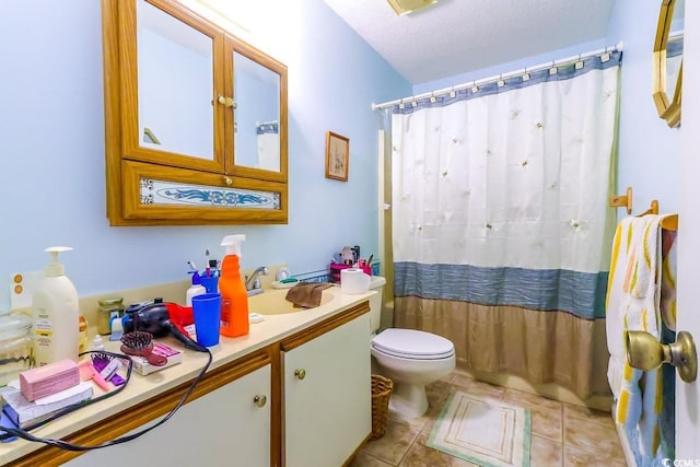 bathroom featuring vanity, a textured ceiling, walk in shower, tile patterned flooring, and toilet