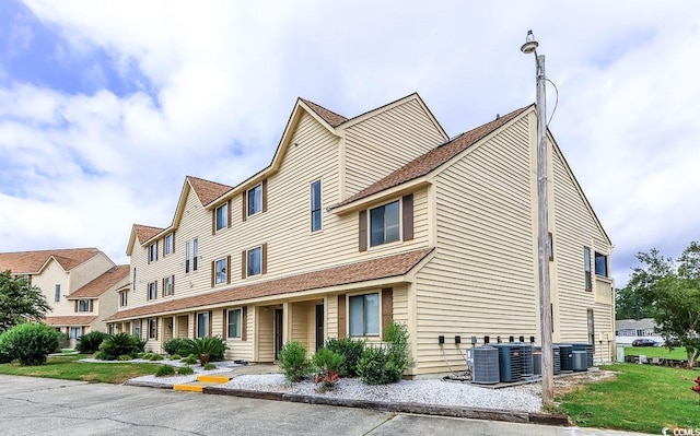 exterior space featuring a front yard and central air condition unit