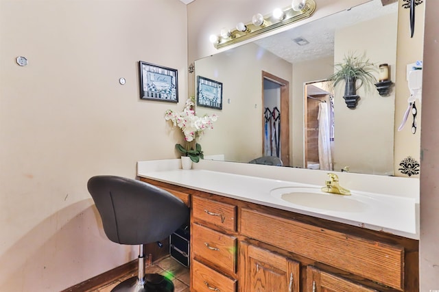 bathroom featuring vanity, a textured ceiling, and tile patterned floors