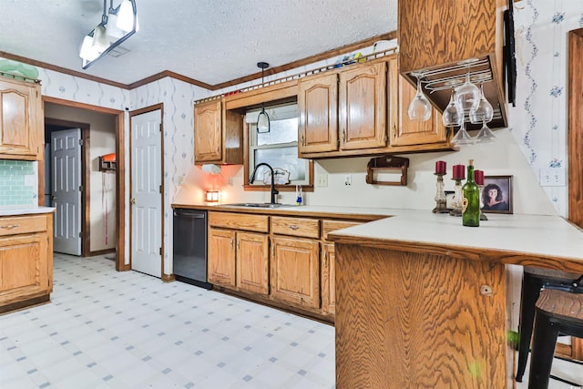 kitchen featuring a textured ceiling, ornamental molding, dishwasher, and sink