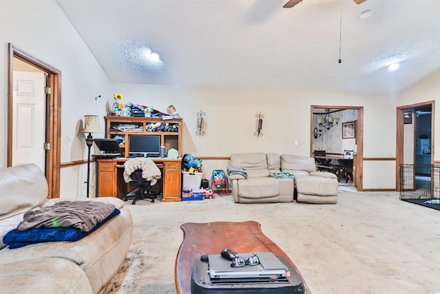 carpeted living room featuring ceiling fan, a textured ceiling, and lofted ceiling