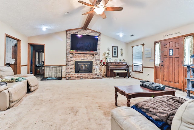 living room featuring lofted ceiling with beams, a textured ceiling, carpet flooring, a fireplace, and ceiling fan