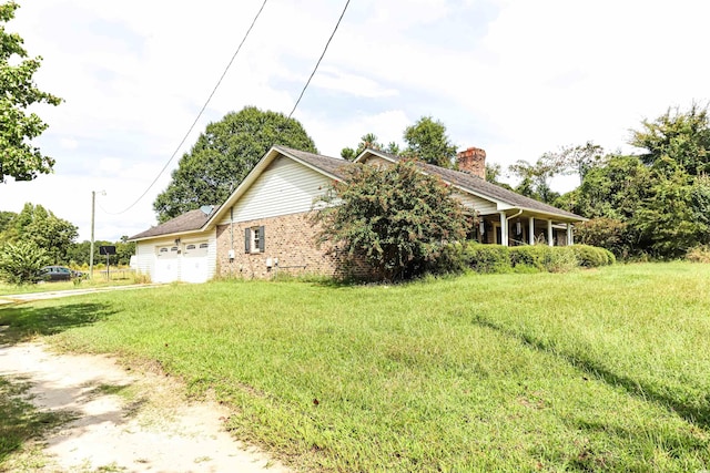 view of home's exterior with a yard and a garage