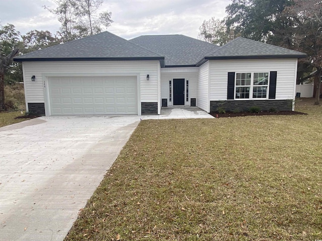 ranch-style house with stone siding, roof with shingles, concrete driveway, an attached garage, and a front yard