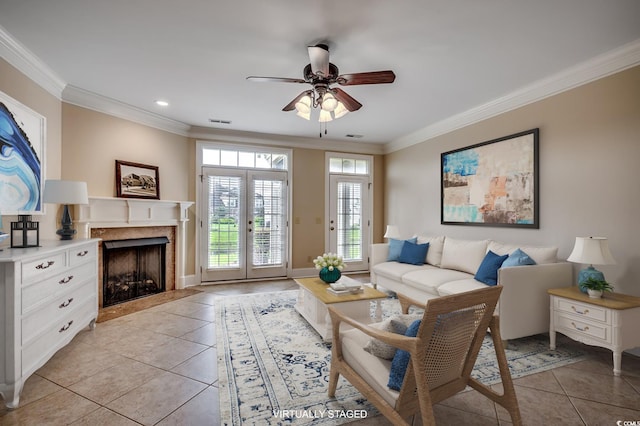 living room featuring light tile patterned floors, french doors, and crown molding