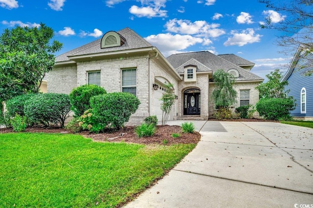 french country home featuring a front lawn